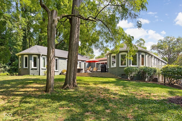 exterior space with brick siding, fence, a front yard, a deck, and crawl space