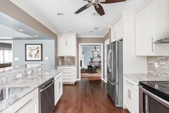 kitchen with white cabinets, appliances with stainless steel finishes, crown molding, and light stone countertops