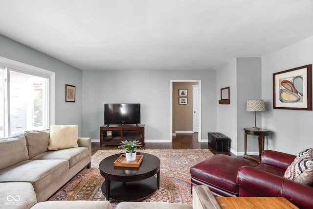 living area with baseboards and dark wood-style floors