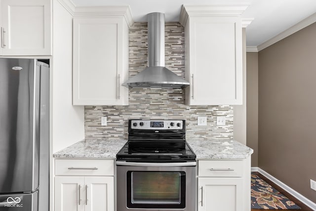 kitchen featuring backsplash, wall chimney range hood, ornamental molding, white cabinets, and stainless steel appliances