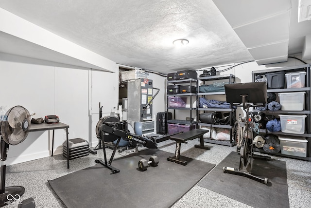 exercise room featuring a textured ceiling