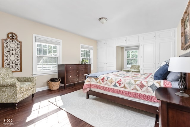 bedroom with baseboards and dark wood-style flooring