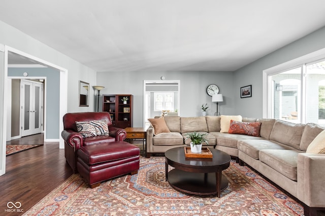 living area with plenty of natural light, wood finished floors, and baseboards