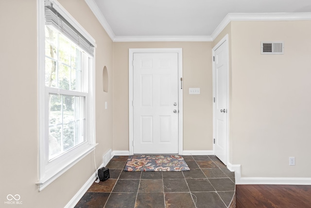 foyer entrance with visible vents, plenty of natural light, crown molding, and baseboards