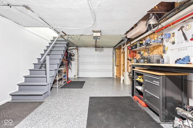 garage with a workshop area and a garage door opener