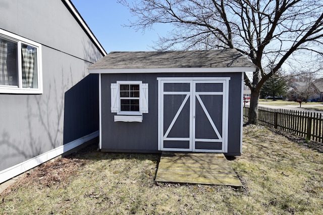 view of shed featuring fence