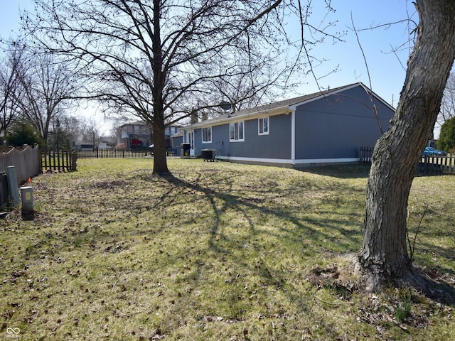 view of yard with fence and central AC