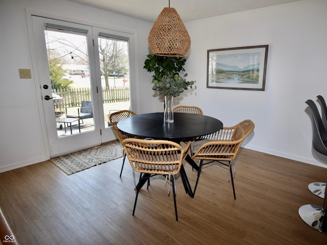 dining room featuring baseboards and wood finished floors