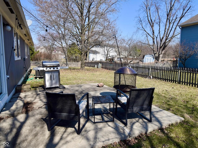 view of patio / terrace with grilling area and a fenced backyard