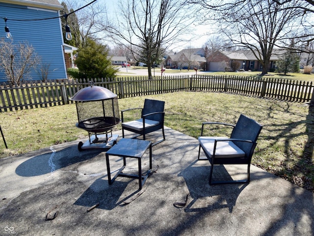 view of patio featuring a residential view, fence private yard, and an outdoor fire pit