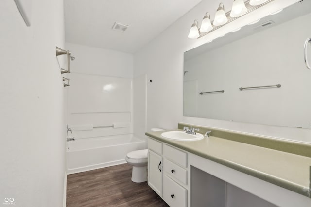 full bathroom featuring visible vents, toilet, wood finished floors, bathtub / shower combination, and vanity