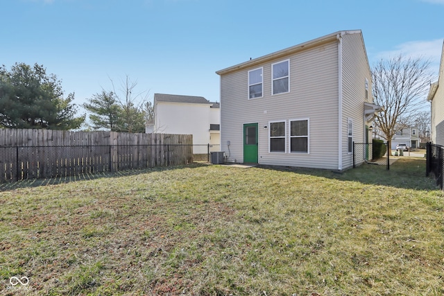 back of property featuring a lawn, cooling unit, and a fenced backyard