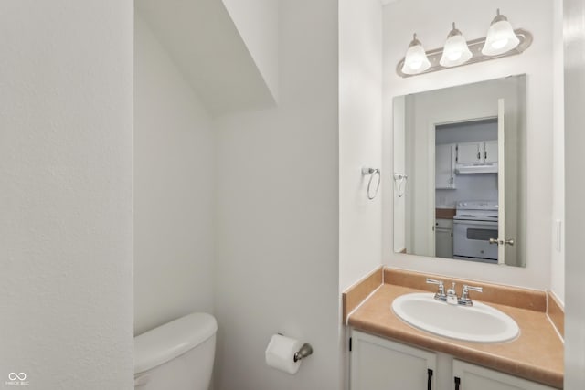 half bathroom featuring toilet and vanity