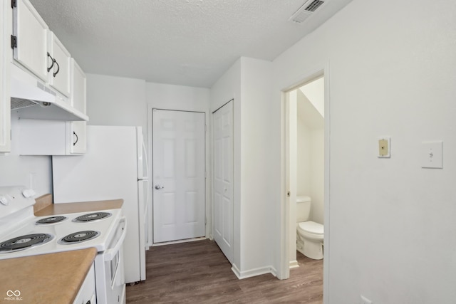 kitchen with visible vents, white electric stove, dark wood finished floors, light countertops, and white cabinetry