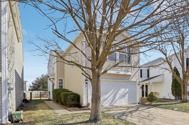 view of front of property with driveway, an attached garage, and fence