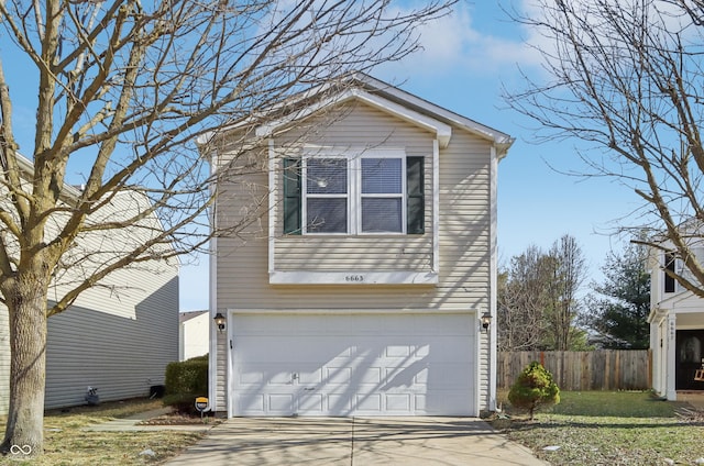 traditional home with fence, a garage, and driveway