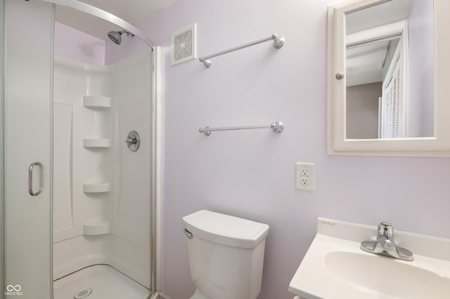 bathroom with visible vents, a shower stall, toilet, and vanity