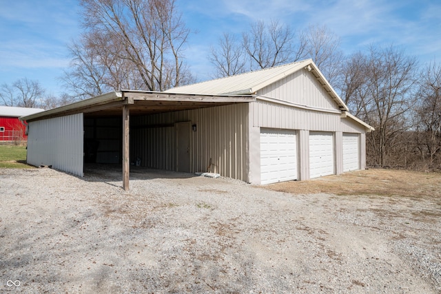 garage with a detached garage and driveway