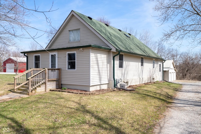 view of front facade featuring a garage, a front yard, and an outdoor structure