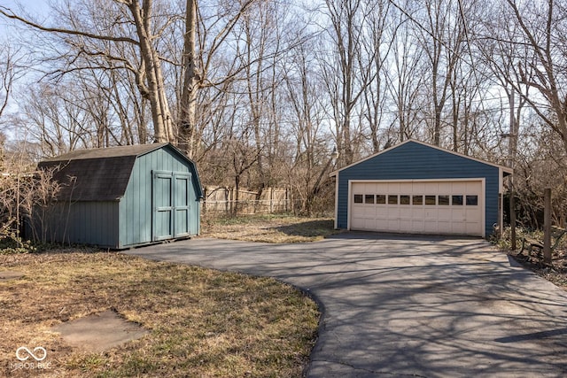 detached garage featuring fence