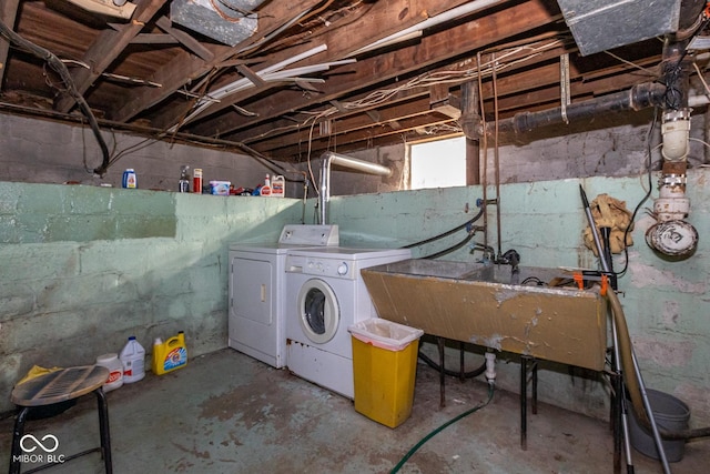 basement with washer and dryer and a sink