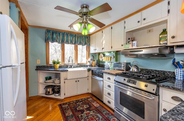 kitchen featuring under cabinet range hood, open shelves, appliances with stainless steel finishes, and a sink