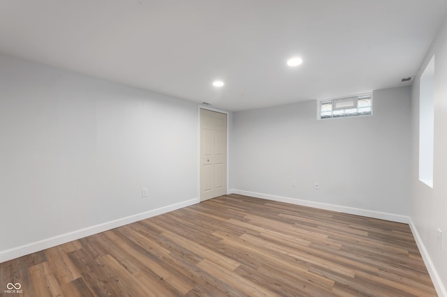 spare room with visible vents, recessed lighting, wood finished floors, and baseboards