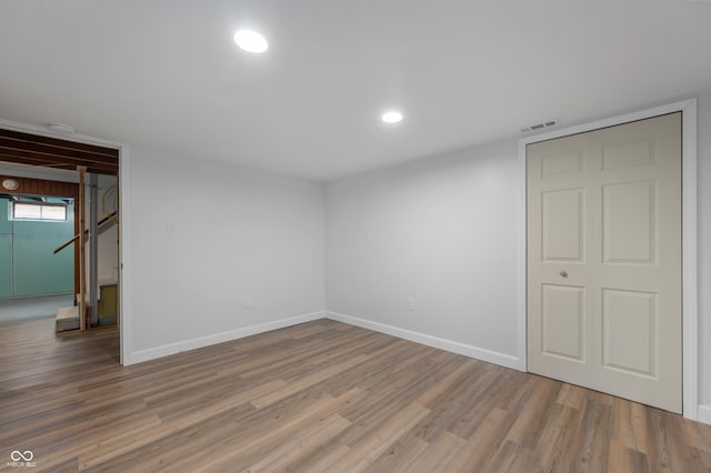 unfurnished bedroom with visible vents, recessed lighting, baseboards, and wood finished floors