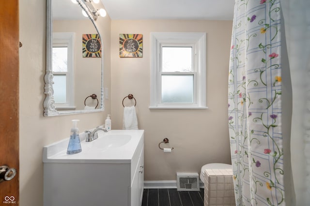 bathroom featuring visible vents, baseboards, and vanity