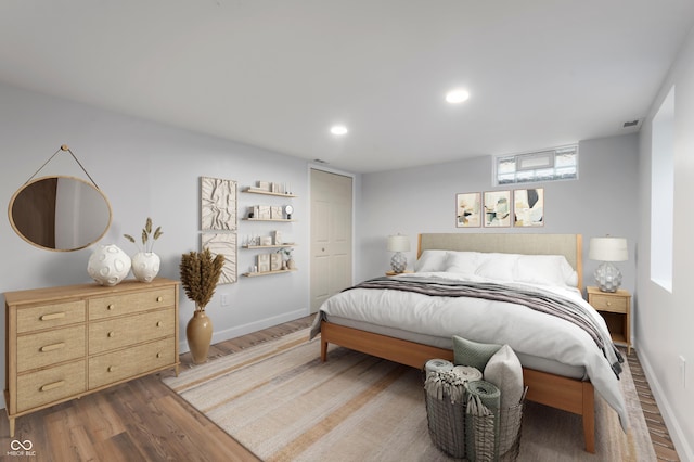 bedroom featuring visible vents, recessed lighting, baseboards, and wood finished floors