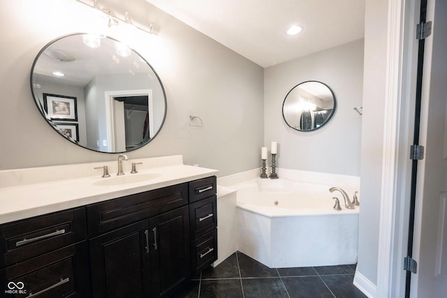 bathroom with tile patterned floors, recessed lighting, vanity, and a whirlpool tub