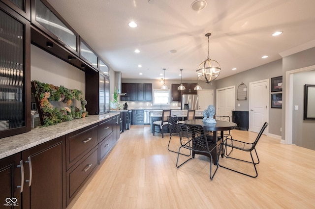 dining room with recessed lighting, a chandelier, and light wood finished floors