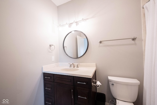 full bathroom with toilet and vanity