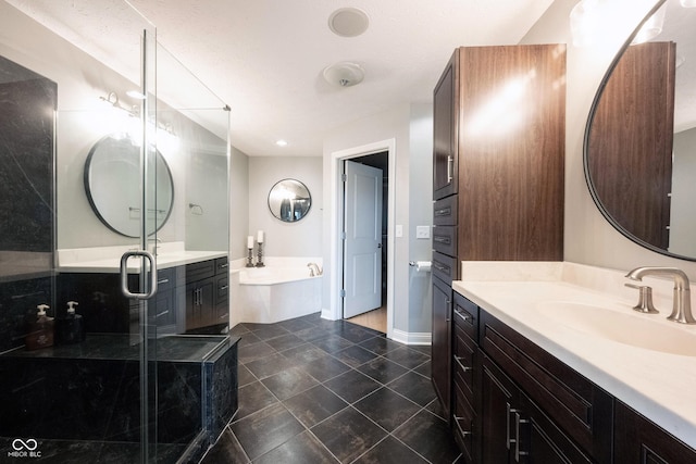 full bathroom featuring tile patterned floors, a stall shower, baseboards, a bath, and vanity