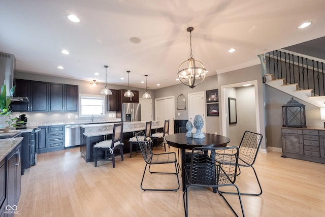 dining space featuring recessed lighting, stairway, light wood-style flooring, and an inviting chandelier