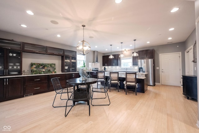 dining room with recessed lighting, visible vents, light wood finished floors, and a chandelier