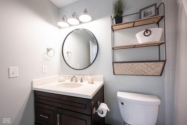 bathroom with toilet and vanity