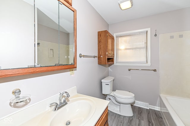 full bath with vanity, toilet, wood finished floors, and visible vents