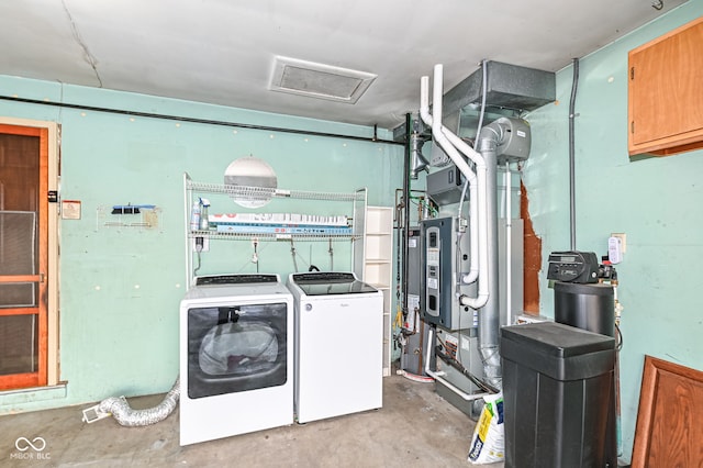 clothes washing area with washer and dryer and attic access