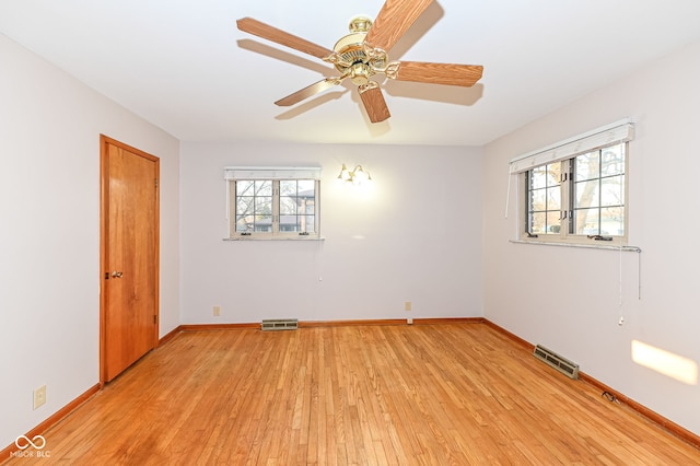 empty room with visible vents, a healthy amount of sunlight, and light wood-style flooring