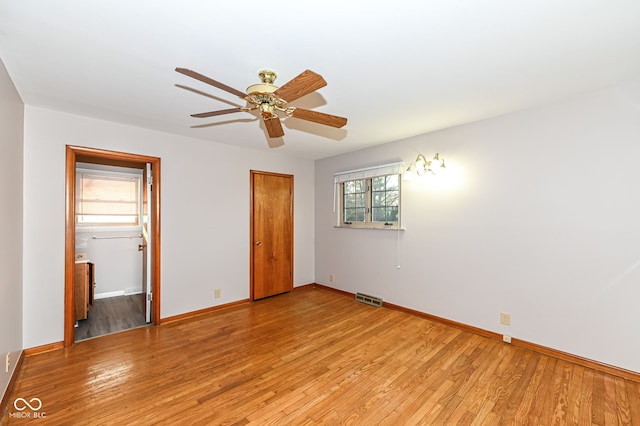 unfurnished bedroom with baseboards, visible vents, a closet, and light wood-type flooring