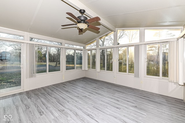 unfurnished sunroom featuring plenty of natural light, ceiling fan, and vaulted ceiling with beams