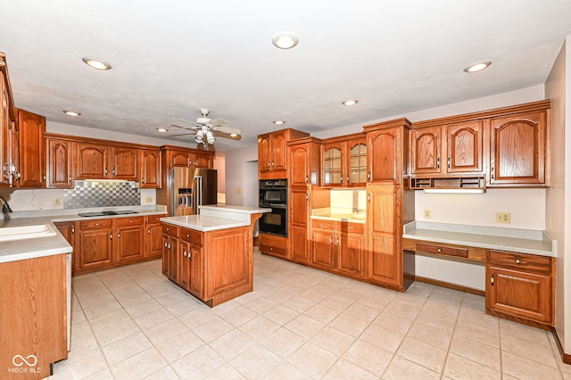 kitchen with black appliances, brown cabinetry, light countertops, and ceiling fan