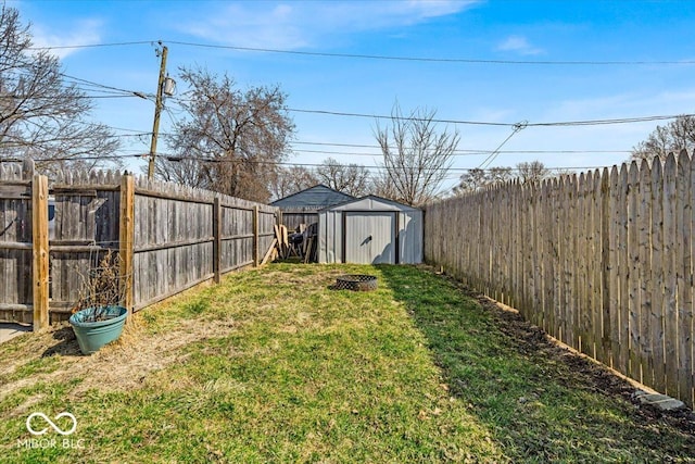 view of yard featuring an outbuilding, a storage shed, and a fenced backyard