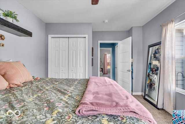 bedroom with carpet flooring, a ceiling fan, a closet, and baseboards