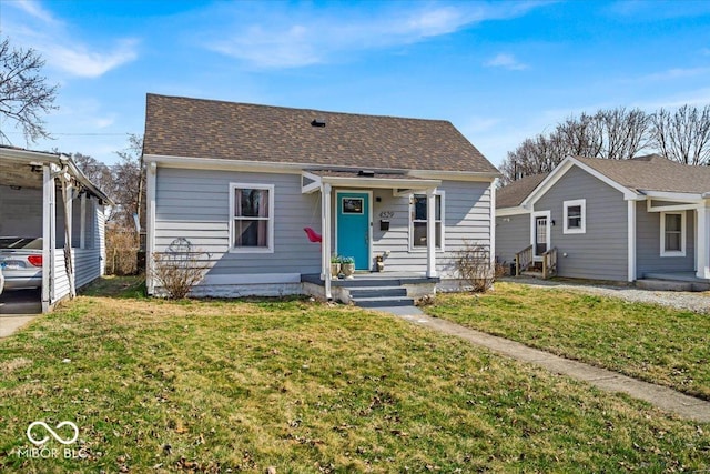 bungalow featuring a front yard and a shingled roof