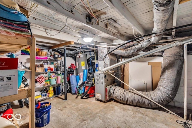 unfinished basement with heating unit and electric water heater