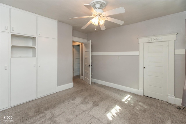 unfurnished bedroom with a closet, a ceiling fan, baseboards, and carpet floors