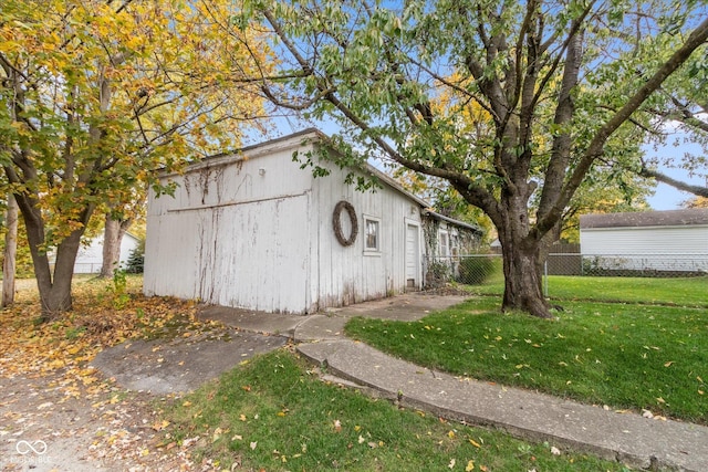 view of outdoor structure featuring an outbuilding and fence