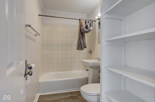 bathroom featuring toilet, wood finished floors, shower / bathtub combination, and ornamental molding